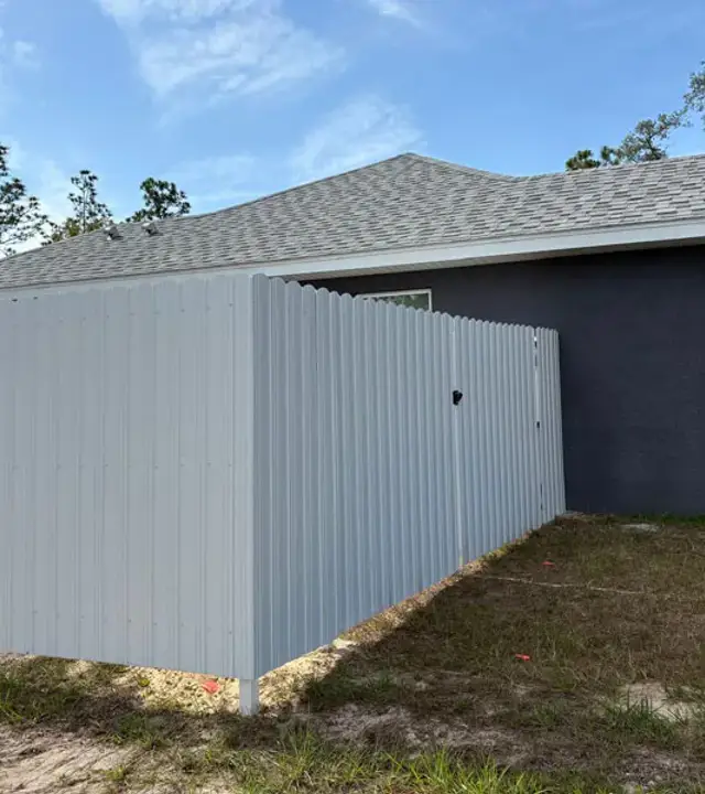 White Durafence steel privacy fence beside a home