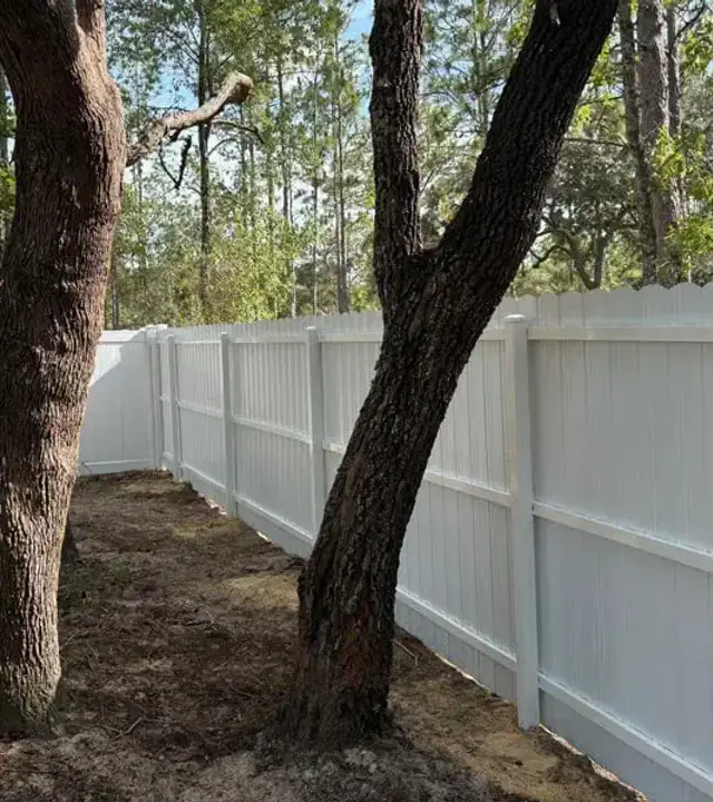 Long white Durafence steel privacy fence around a yard