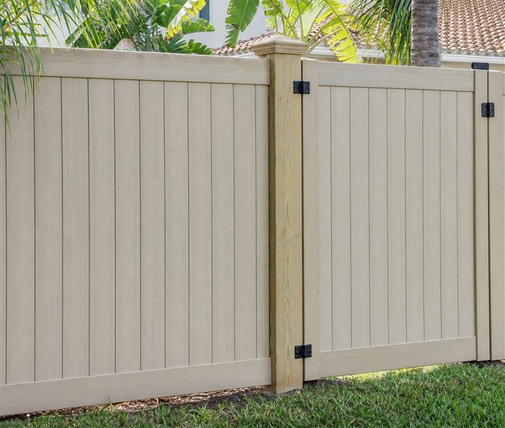 Repaired residential fence section with fresh post and hardware